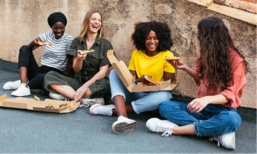 Women having fun eating pizza